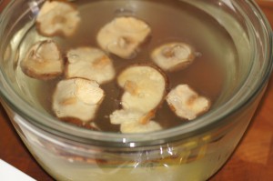 Dry Shiitake Mushrooms Rehydrating in Bowl of Water