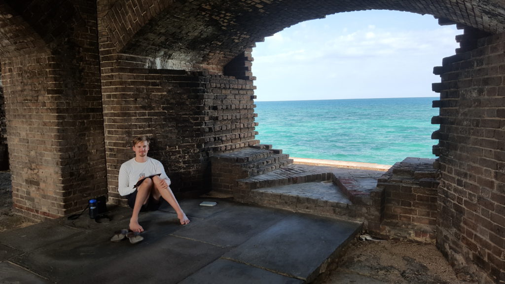 Corey Sitting Inside Fort Jefferson Writing