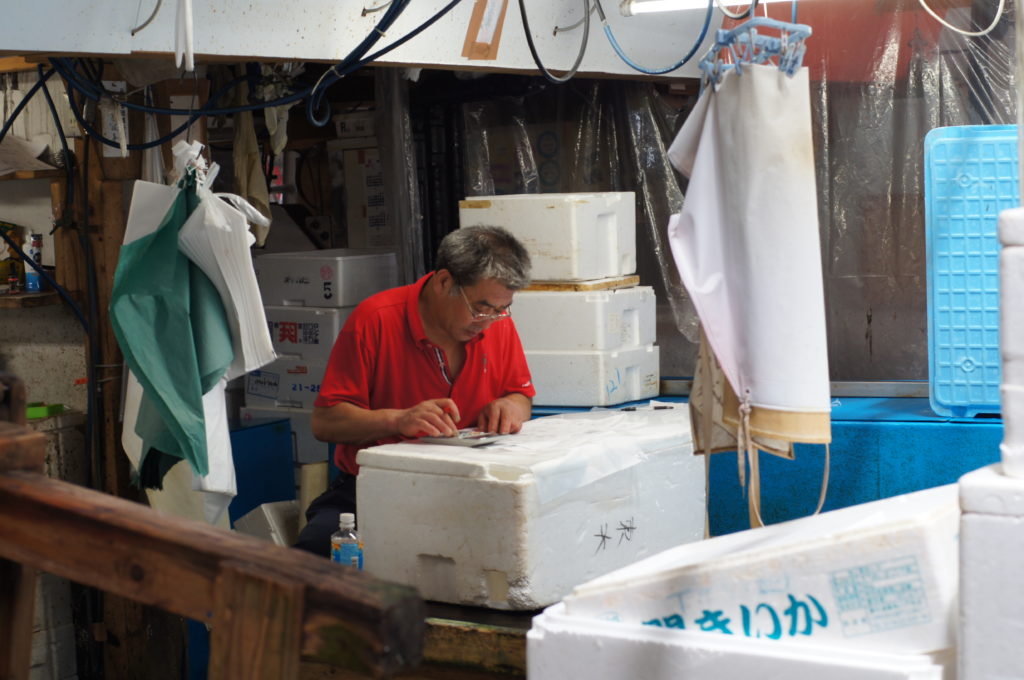 Tsukiji Market Wholesaler Calculating the Sales for the Day