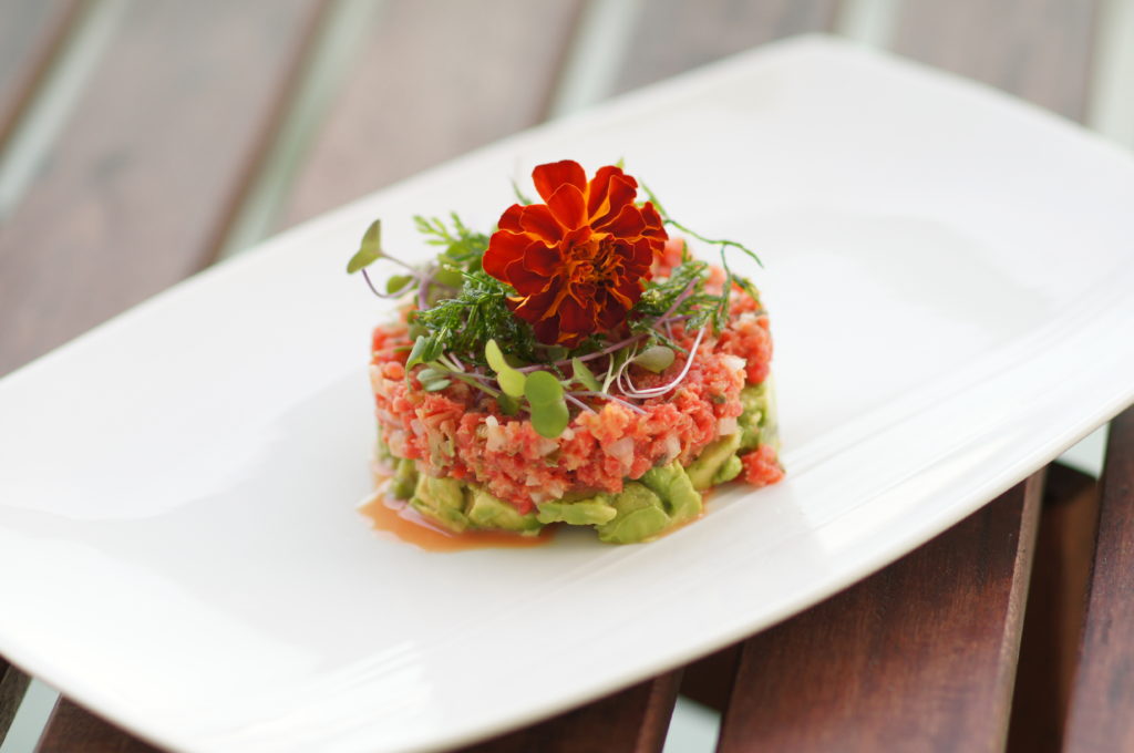 Carrot Tartare with Microgreens, Fried Carrot Tops, and Edible Flowers 