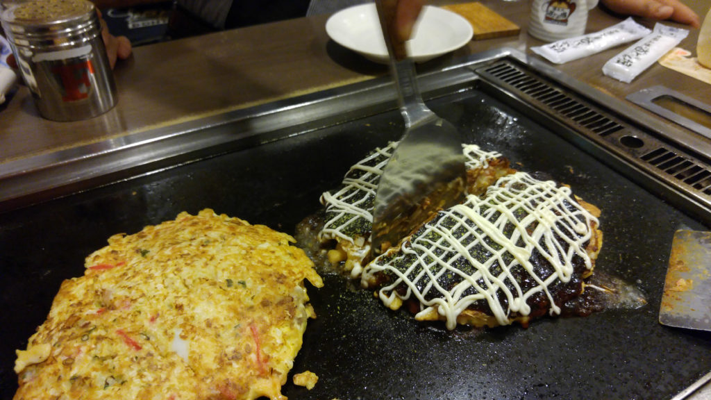 Cutting Okonomiyaki at Dohtonbori Restaurant